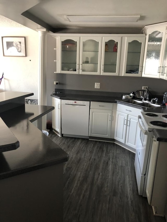 kitchen with white appliances, white cabinetry, sink, and dark hardwood / wood-style floors