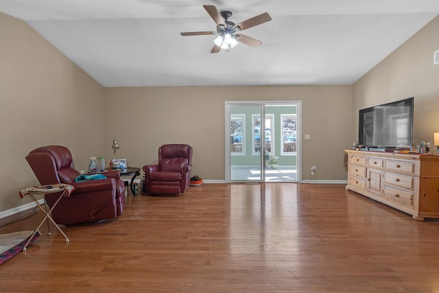 sitting room with hardwood / wood-style flooring, vaulted ceiling, and ceiling fan