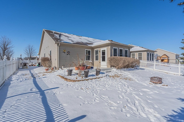 snow covered property featuring a fire pit