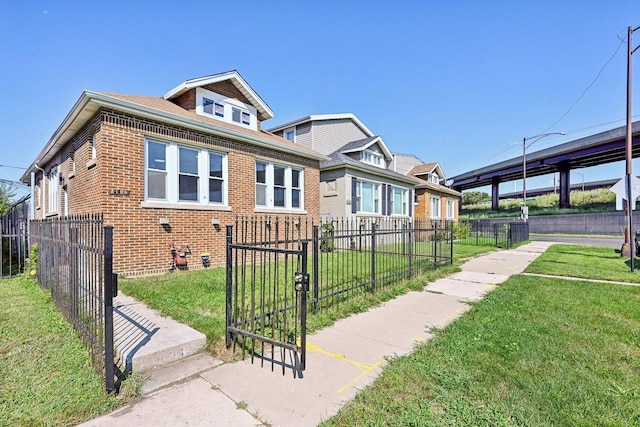 bungalow-style house with a front lawn