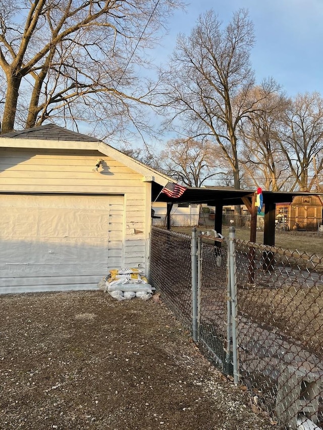 view of side of property with a garage and an outbuilding