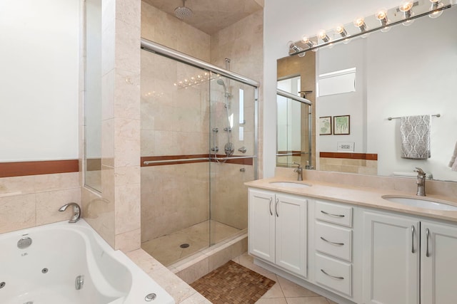 bathroom with plus walk in shower, vanity, and tile patterned flooring