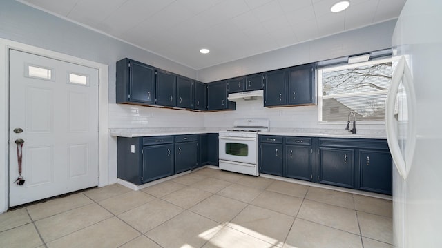 kitchen with blue cabinets, sink, tasteful backsplash, light tile patterned floors, and white appliances