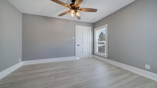 unfurnished room featuring ceiling fan and light wood-type flooring