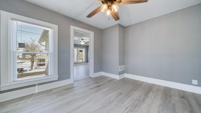 spare room with ceiling fan and light hardwood / wood-style floors