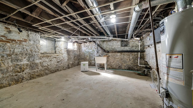 basement featuring sink and water heater