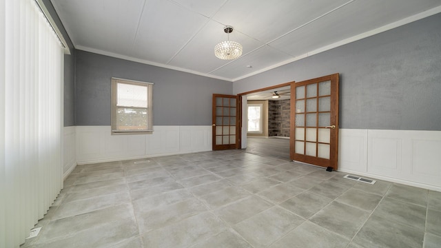 spare room with crown molding and light tile patterned floors