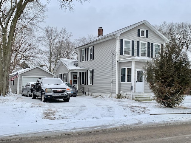 view of front of house with a garage and an outdoor structure