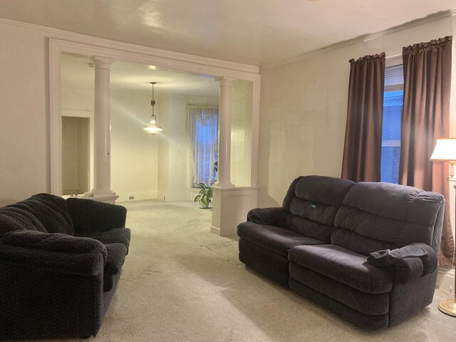 living room with ornate columns, crown molding, and light colored carpet