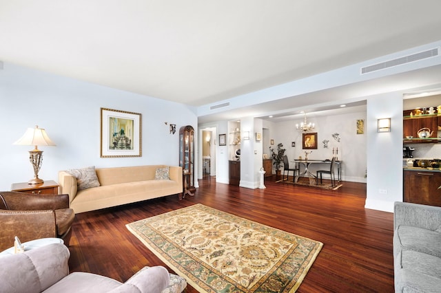 living area featuring wood finished floors, visible vents, and baseboards