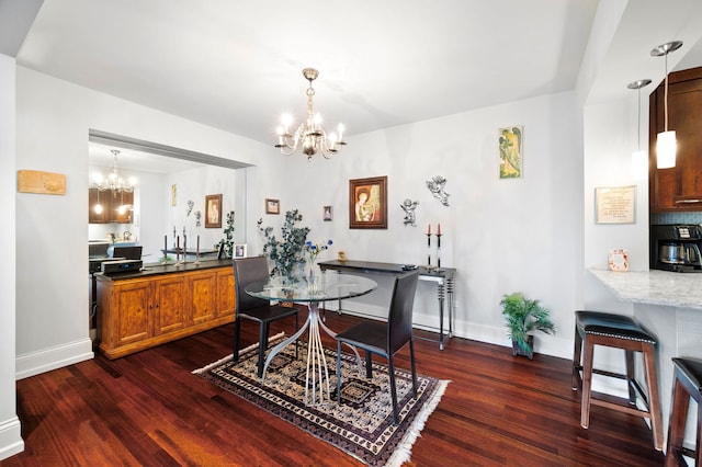 dining area featuring baseboards, dark wood finished floors, and a notable chandelier