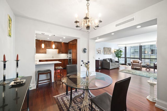 dining room featuring dark wood-type flooring, recessed lighting, visible vents, and an inviting chandelier