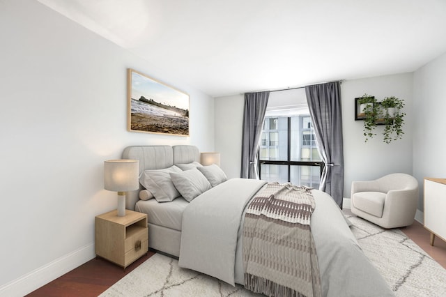 bedroom featuring baseboards and wood finished floors