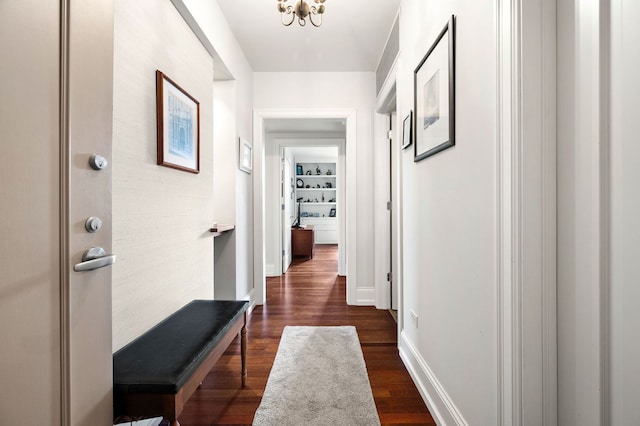 hall featuring dark wood-style floors and baseboards