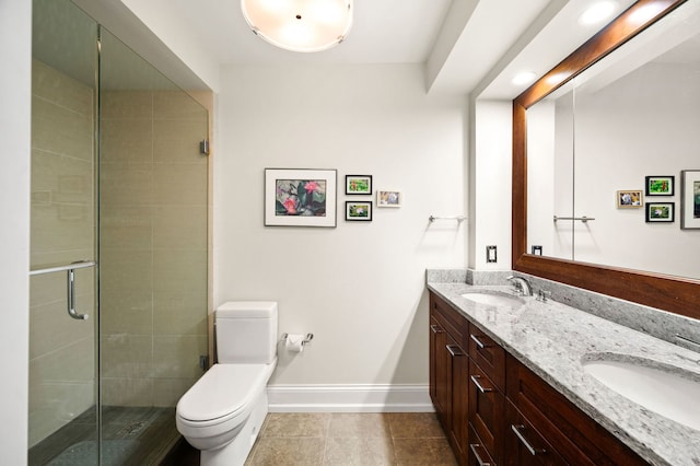 full bathroom featuring toilet, a shower stall, double vanity, and a sink