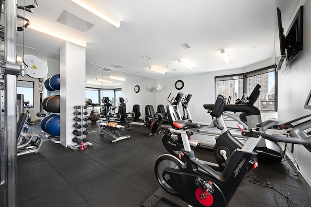 workout area with visible vents and a healthy amount of sunlight