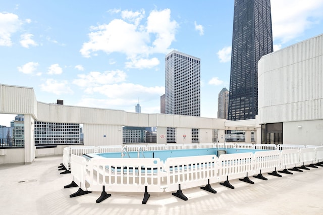 view of pool featuring a view of city