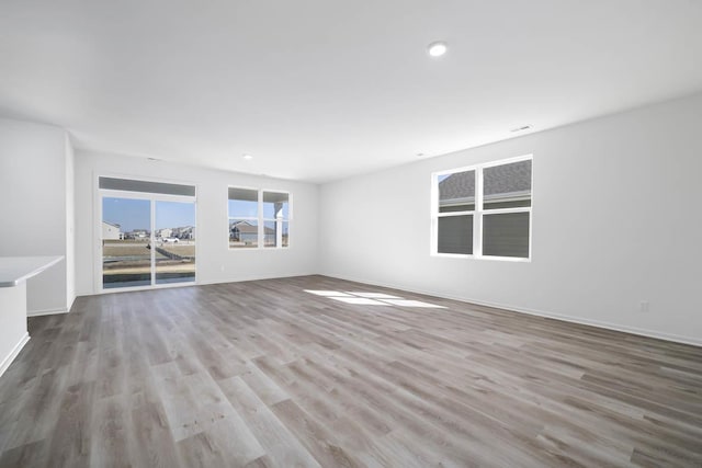 spare room with light hardwood / wood-style floors