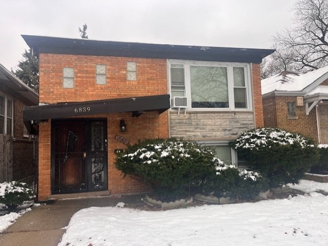 view of snow covered property entrance