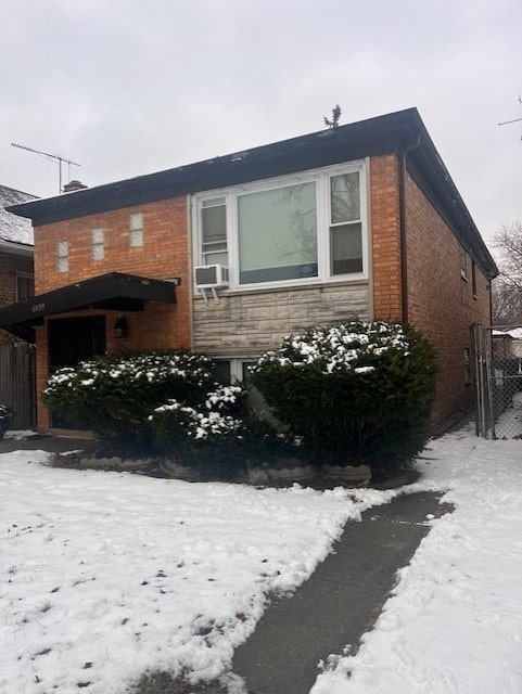 view of snowy exterior featuring cooling unit