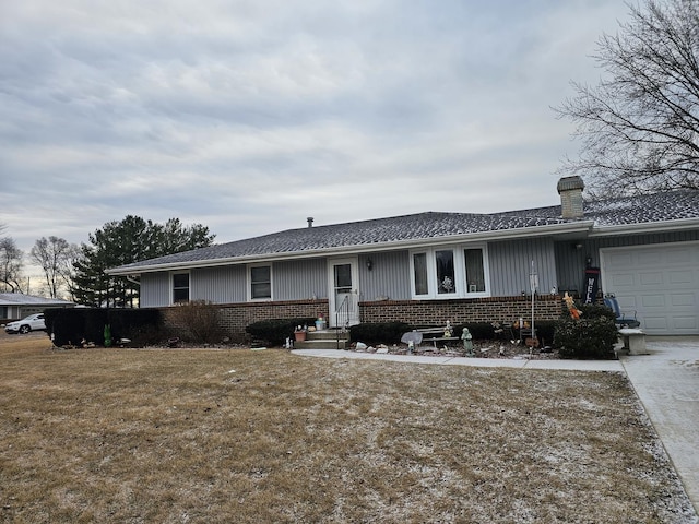 ranch-style house with a front yard and a garage