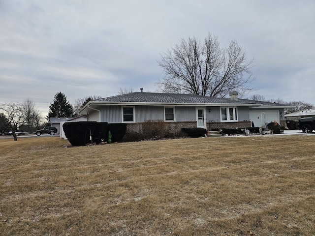 single story home featuring a front yard and a garage