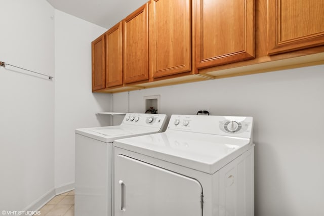 laundry room with cabinets, separate washer and dryer, and light tile patterned floors