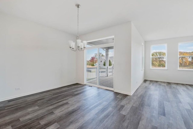 unfurnished dining area featuring dark wood-type flooring and a chandelier