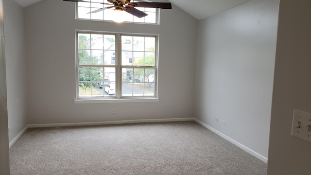 unfurnished room with plenty of natural light, carpet flooring, and lofted ceiling