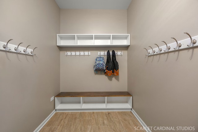 mudroom with baseboards and wood finished floors