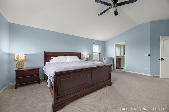 bedroom featuring lofted ceiling, light colored carpet, ensuite bathroom, ceiling fan, and baseboards