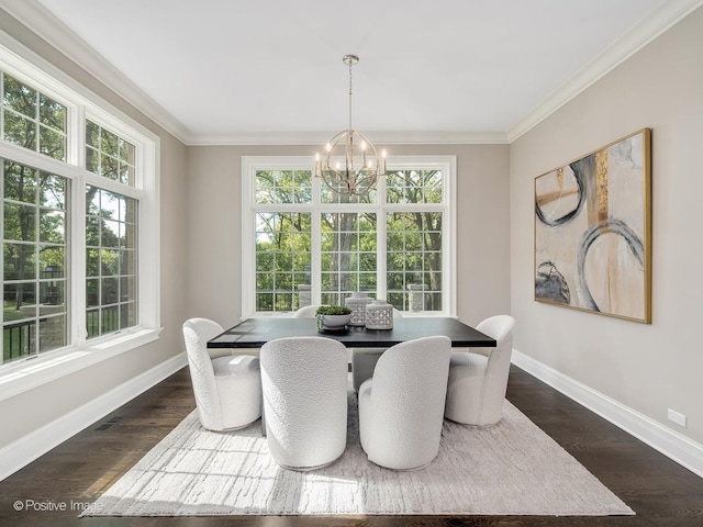 dining area featuring dark wood-type flooring, ornamental molding, and a chandelier