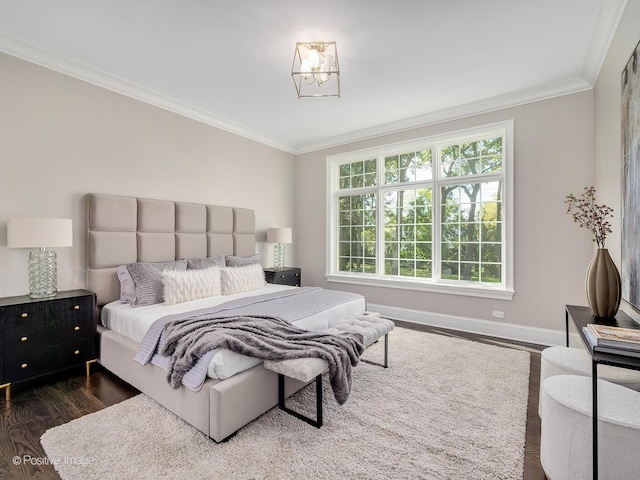 bedroom featuring ornamental molding and dark hardwood / wood-style flooring