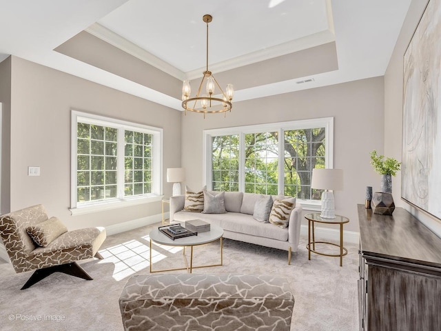 living room with light carpet, a raised ceiling, and an inviting chandelier