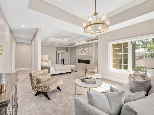 living room featuring a raised ceiling, a premium fireplace, light colored carpet, and crown molding