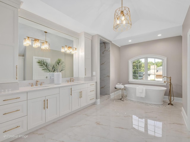 bathroom with a bathing tub, lofted ceiling, and vanity