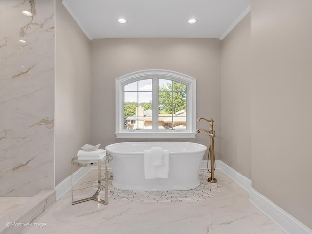 bathroom with a washtub and crown molding