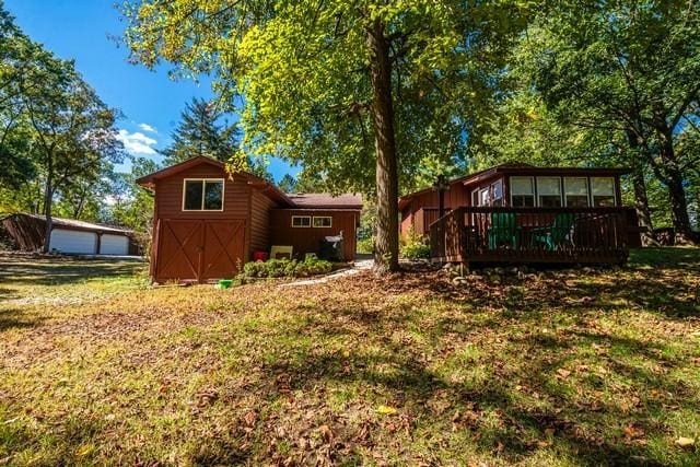 7623 288th Ave, Salem, WI 53168 - rear view of house featuring an outdoor structure, a deck, and a lawn