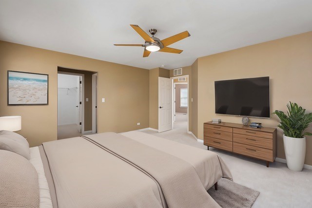 bedroom featuring light carpet and ceiling fan