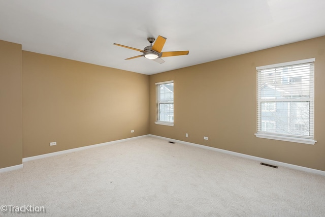 carpeted empty room featuring ceiling fan