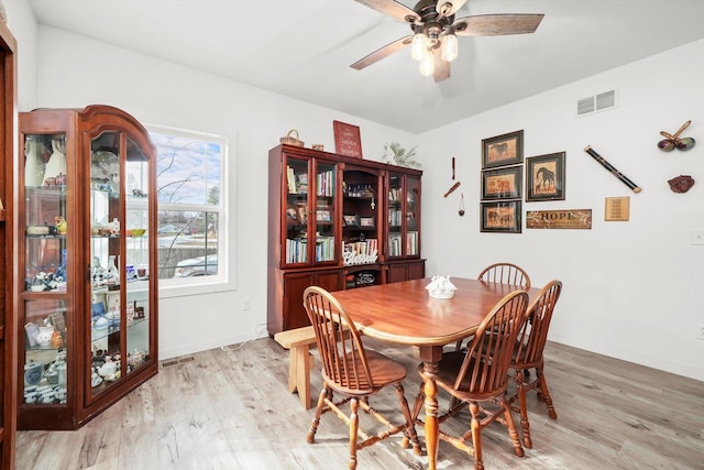 dining room with light hardwood / wood-style flooring and ceiling fan