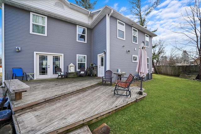 rear view of house with a wooden deck, a lawn, french doors, and central air condition unit