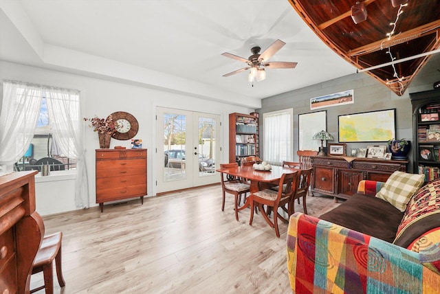 dining room featuring french doors, ceiling fan, light hardwood / wood-style floors, and a wealth of natural light