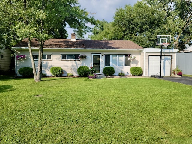 ranch-style home featuring a garage and a front lawn