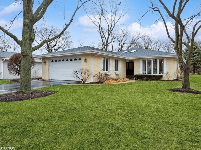 ranch-style house featuring an attached garage, driveway, brick siding, and a front yard