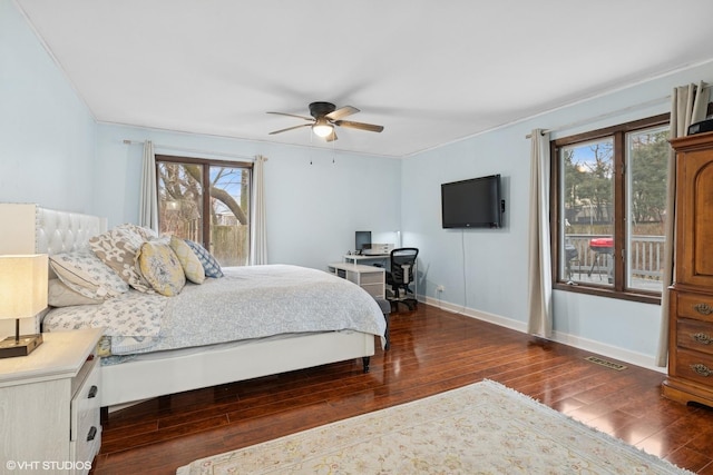 bedroom with ceiling fan, hardwood / wood-style floors, visible vents, and baseboards