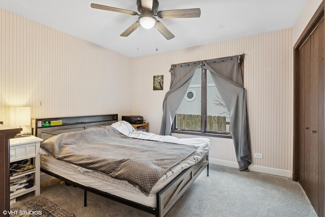 bedroom featuring ceiling fan, carpet floors, baseboards, a closet, and wallpapered walls