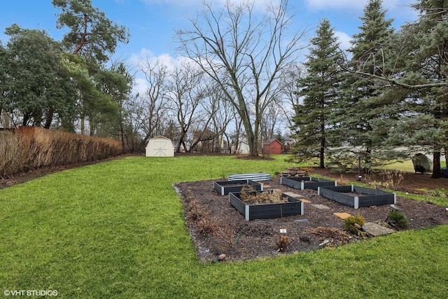 view of yard featuring an outbuilding, a shed, and a garden