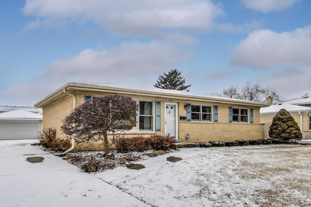 view of front of home with a garage and an outdoor structure