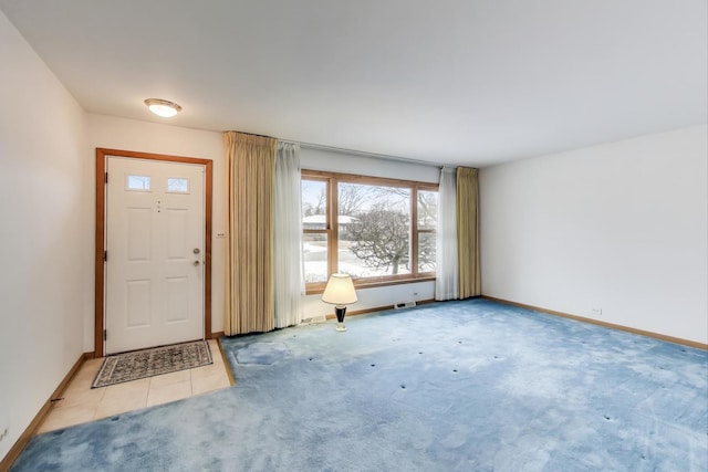 foyer featuring light carpet